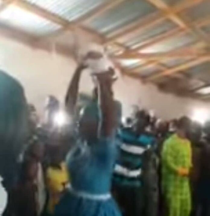 An infant being manhandled at church service