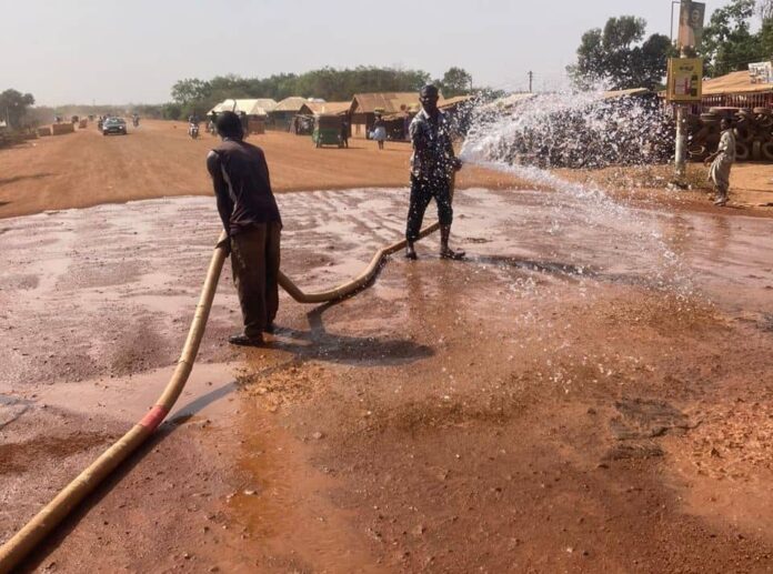 Yarigabiisi Assemblyman supervising watering of unpaved roads