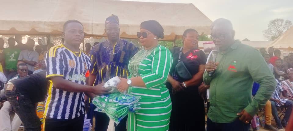 NDC Upper East Regional Women's Organizer (in glasses) hands over jersey to participating teams