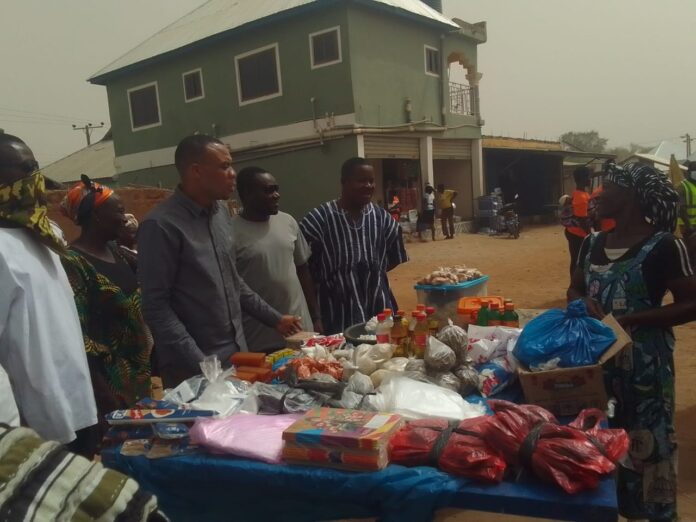 Kassena-Nankana West DCE speaks with a trader at the Mirigu Market